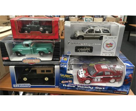 Four 1/18 scale diecast cars, includes Universal Hobbies Land Rover (one part loose in box, possibly exhaust) and Anson Cadil