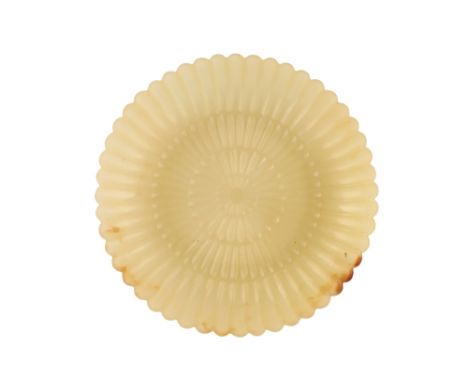 SMALL TRANSLUCENT YELLOW JADE SAUCER DISH, QIANLONG PERIOD, finely carved as a formalised chrysanthemum flower, a slight brow