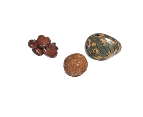 THREE JAPANESE NETSUKE, EDO / MEIJI PERIOD, comprising a carved walnut, an 'amber' peach group, and a lacquer netsuke (3) 