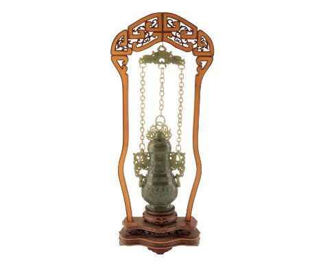 SPINACH JADE HANGING VASE ON WOODEN STAND, REPUBLIC PERIOD, of flattened baluster form, carved with stylised motifs, the twin