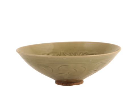 LARGE YAOZHOU 'PEONY-SCROLL' CARVED BOWL, NORTHERN SONG DYNASTY, of gently-rounded form covered in a glassy olive-toned glaze