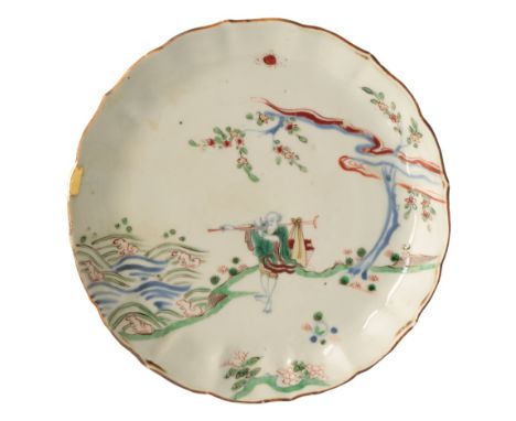 WUCAI BARBED-RIM 'NARRATIVE' DISH, TIANGI / CHONGZHEN PERIOD, freely painted with a wandering scholar carrying a package over