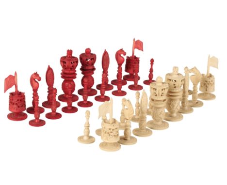 CANTONESE IVORY CHESS SET, QING DYNASTY, 19TH CENTURY, one side in natural ivory, the other stained red, the kings as pierced