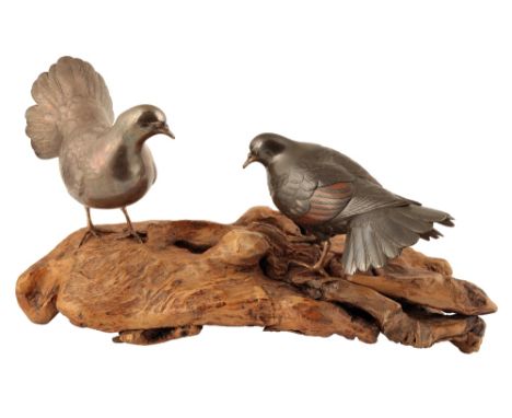 FINE SILVER AND BRONZE GROUP OF TWO DOVES, BY SEIFU, MEIJI PERIOD, raised on a naturalistic rootwood base, 23cm high (with ba
