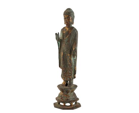 GILT-BRONZE STANDING BUDDHA, KOREAN 18TH CENTURY, modelled standing on a double lotus pedestal and wearing a voluminous long 