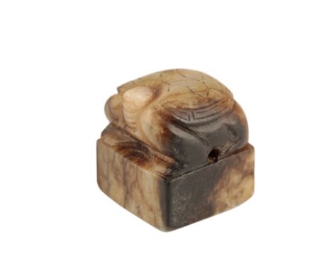 MINIATURE CREAM AND DARK JADE 'BIXI' SEAL, HAN DYNASTY, the creature on a square base, 2cm wide Provenance: Purchased in Sian