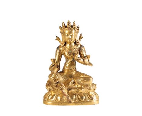 GILT BRONZE FIGURE OF TARA, TIBET, 17TH / 18TH CENTURY, seated in lalitasana on a double lotus throne the left hand raised in