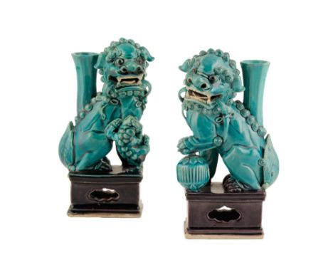 PAIR OF TURQUOISE-GLAZED BUDDHISTIC LION JOSS STICK HOLDERS, QING DYNASTY, each creature seated on its hind legs on a pierced