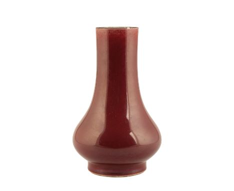 LANGYAO BOTTLE VASE, KANGXI PERIOD, the deep red glaze thinning at the top rim and pooling a little at the foot, the base wit