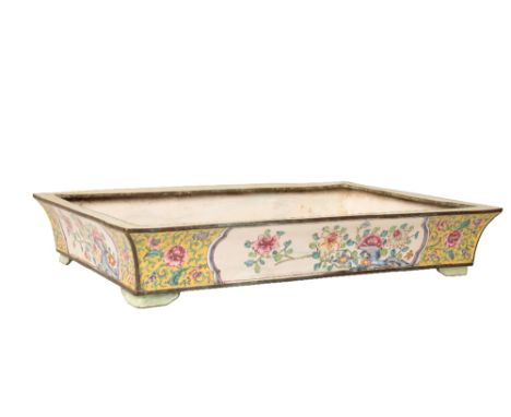 CANTON ENAMEL RECTANGULAR JARDINIÈRE, QIANLONG PERIOD, the flared and waisted sides decorated with flower panels on a foliate