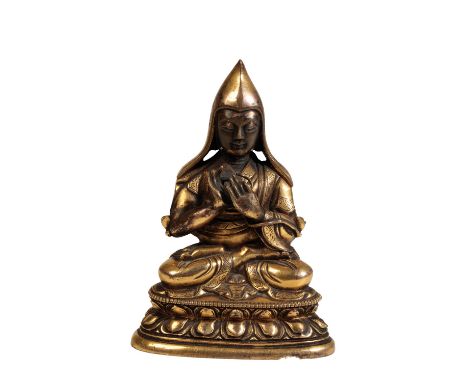 GILT BRONZE SEATED BUDDHA, SINO-TIBETAN, 17TH / 18TH CENTURY, seated in vajraparyanksana on a double lotus pedestal base, wea