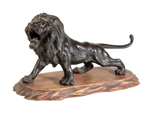 JAPANESE BRONZE LION, SIGNED GENRYUSAI SEIYA, MEIJI PERIOD, the rampant beast realistically cast with head turned to side, 20