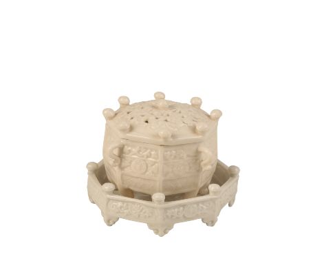 DEHUA OCTAGONAL 'MARCO POLO' CENSER AND STAND,KANGXI PERIOD, the foliate-moulded and pierced cover surmounted with nine relie
