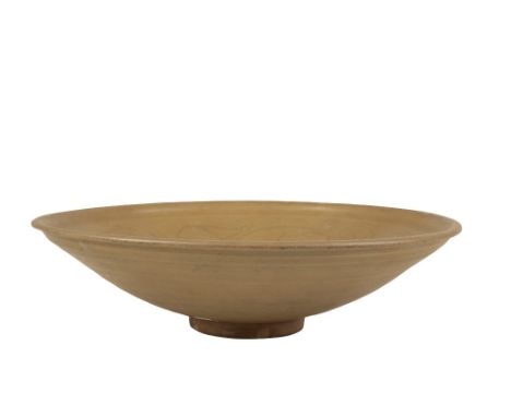CELADON SHALLOW DISH, SONG DYNASTY, the gently rounded body with an everted rim, the centre carved with a goose in flight sur