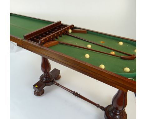 VICTORIAN MAHOGANY BAGATELLE TABLE having a folding top opening to reveal a baize-lined playing interior complete with balls,