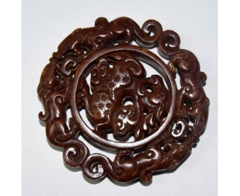 A Chinese jade bi with mythical lion decoration