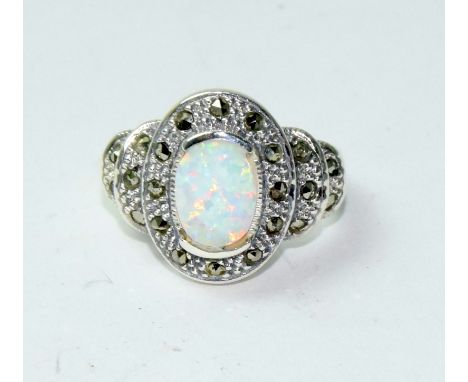 A silver marcasite and opal dress ring