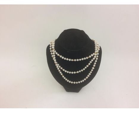 A pearl guard chain with gold spacers