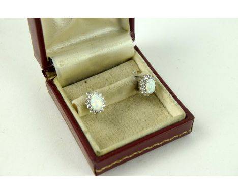 A pair of silver, cz and opal cluster earrings