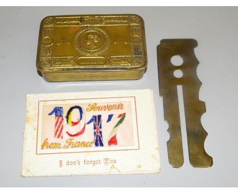 A WW1 Princess Mary tin with a 1917 silk card and a brass button stick