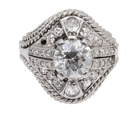 A diamond-set ringthe central modified old brilliant-cut diamond  estimated to weigh +/- 2cts to the ornate border set with o
