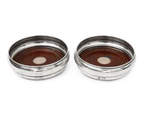 A pair of Elizabeth II silver wine coastersBirmingham, 1989/1990, W I Broadway &amp; Coturned mahogany bases with central but