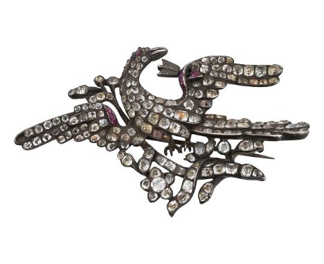 A late 18th/early 19th century paste broochdepicting a bird of paradise with outstretched wing, one pierced by an arrow, amid