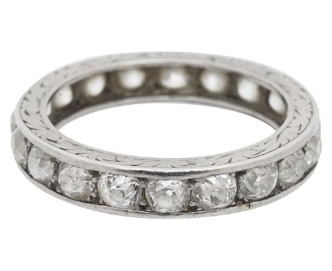A full diamond set eternity ringcomprising of twenty old cut thread and grain set diamonds with engraved detail on the side. 