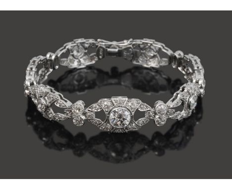 A pretty diamond flexible link braceleteach slightly graduated openwork shaped oval link set with old-cut diamonds  to a cent