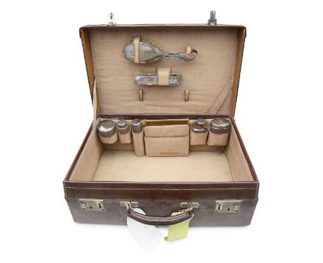 A George V tan leather travelling case with silver mounted fittingsLondon, 1926 PWGcontaining hairbrush, silver backed clothe