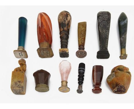 A collection of desk seals mostly with hardstone handleslate 19th / early 20th centuryto include a rose quartz and silver-gil