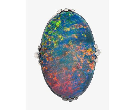 An opal doublet ringthe flat oval opal doublet claw-set to the plain shank stamped '18CT'ring size G, 4.0gCondition:Overall c