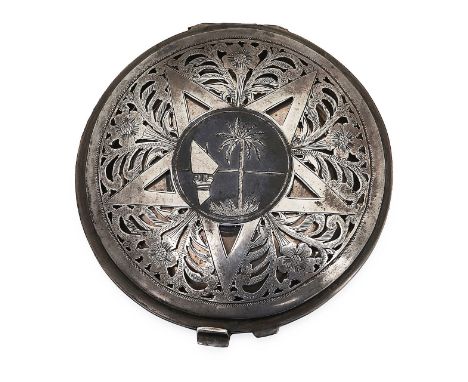 An Iraqi silver and niello powder compactunmarkedthe pierced hinged cover decorated with a typical central river scene with a