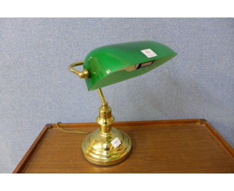 A student's brass desk lamp with green shade