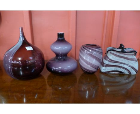 Four amethyst coloured glass vases