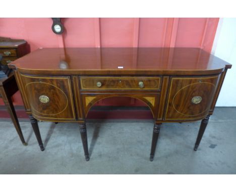A George IV inlaid mahogany bow front sideboard