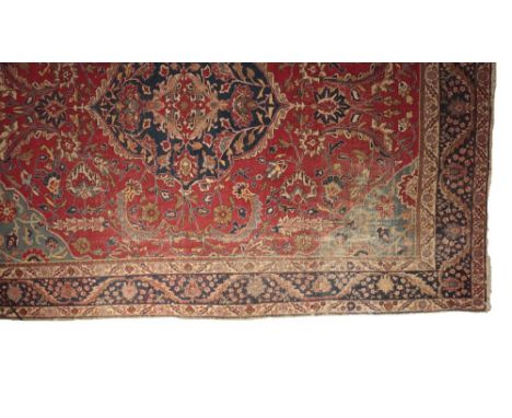 'KASHAN' STYLE FLORAL CARPET, red ground with dark blue central medallion, light blue corner spandrels, and a contrasting dar