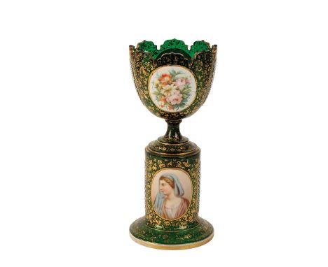 A 19TH CENTURY BOHEMIAN GREEN OVERLAID PEDESTAL VASE  the castellated border above oval panels decorated with flowers and con
