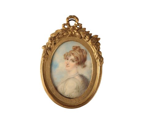 FRENCH SCHOOL, PORTRAIT MINIATURE OF A LADY wearing pearls around her neck and in her hair, 9.5cm x 7.5cm in an oval brass fr