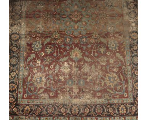 'ISFAHAN' STYLE CARPET, the central light blue medallion, on a dark red and brown ground, with acanthus and floral curvilinea