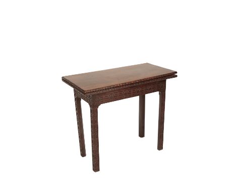 GEORGE II MAHOGANY CARD TABLE of Chinese Chippendale design, the folding rectangular baize-lined top with an edge carved with