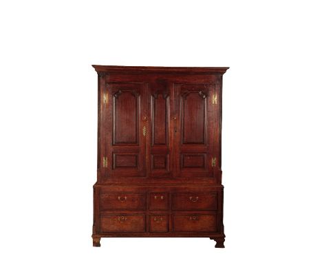GEORGE III PROVINCIAL OAK PRESS CUPBOARD with two panelled doors with ogee-arched tops flanked by fluted quarter pilasters an