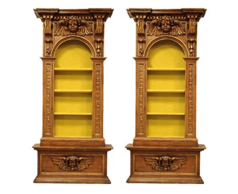 PAIR OF "BAROQUE" WALNUT AND PARCEL-GILT LIBRARY BOOKCASES of architectural form with carved and painted decoration, each wit