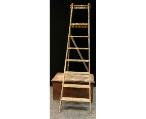 A pair of wooden folding step ladders, 212cm long;  a rectangular pine trunk, hinge lid, 84cm wide, 44.5cm high, 46.5cm deep 