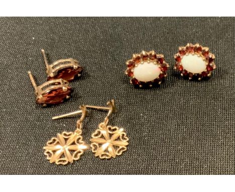 A pair of 9ct gold opal &amp; garnet cluster earrings; a pair of 10ct gold earrings set with marquise garnets; a pair of yell