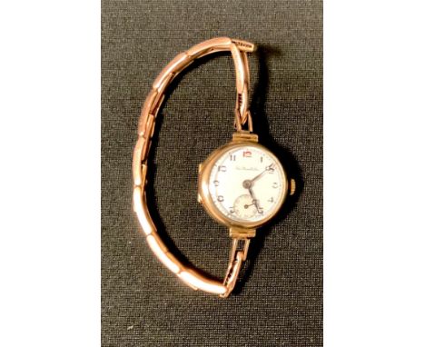 A Thos. Russell &amp; Sons 9ct gold lady's wristwatch, white enamel dial, black Arabic numerals, subsidiary second dial, 7 je