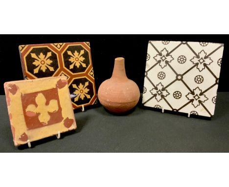 A 19th century Campbell Brick and Tile company encaustic tile, decorated with geometric leafy array; others unmarked;  a terr