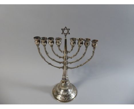 A Silver Jewish Candlestick, Hanukkah Menorah with Star of David and Foliate Decoration in Relief, 24.5 cm High