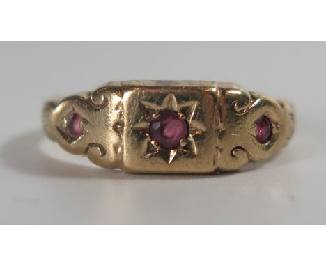 A 9ct Gold and Ruby Three Stone Gypsy Ring, size M.75, 2.3g 