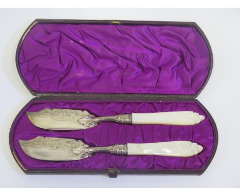 A Cased Pair of Victorian Silver and Mother of Pearl Butter Knives with chased foliate decoration, Birmingham 1875, Hilliard 